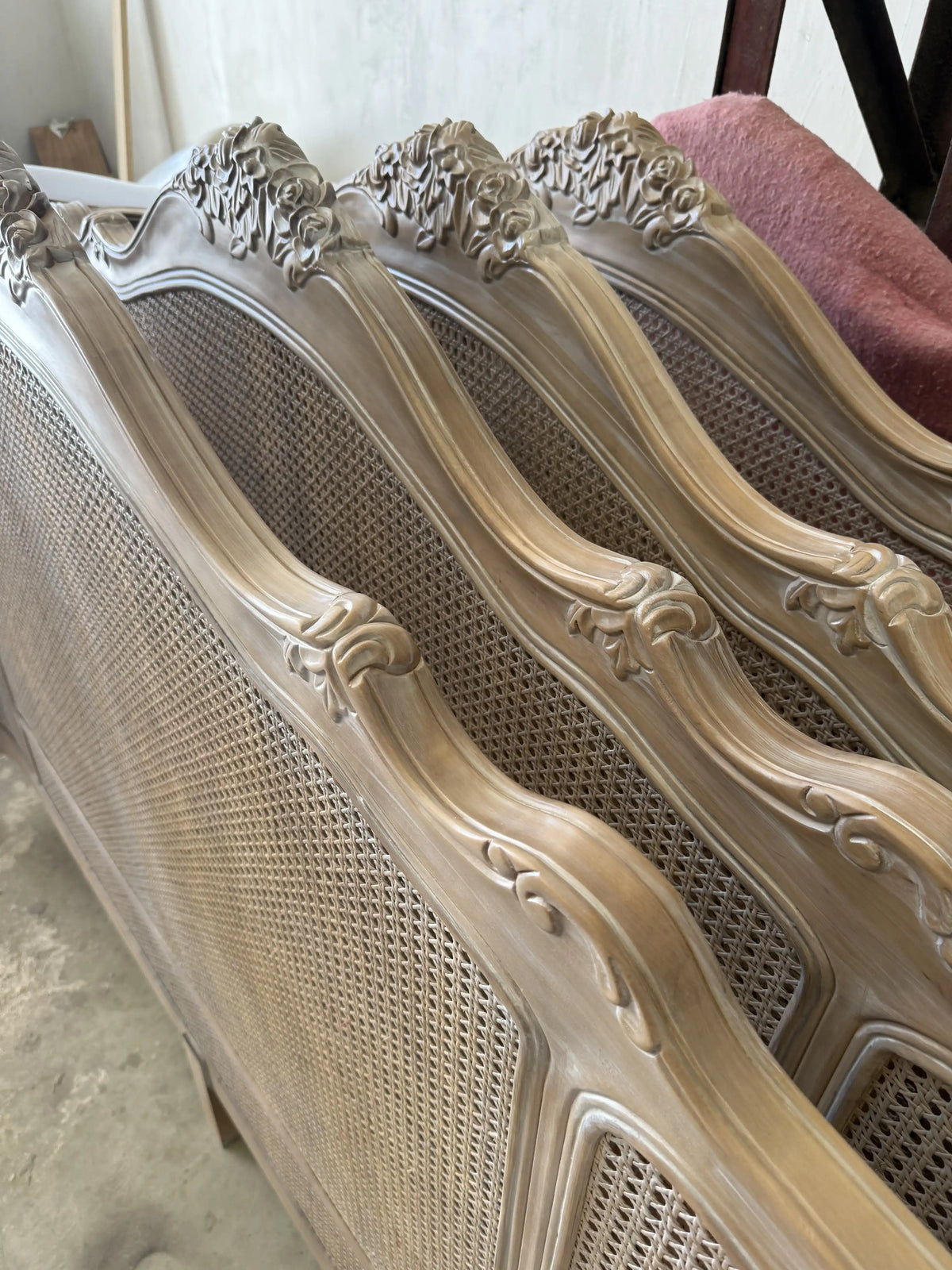 Finished headboards leaning in a row along the workshop wall
