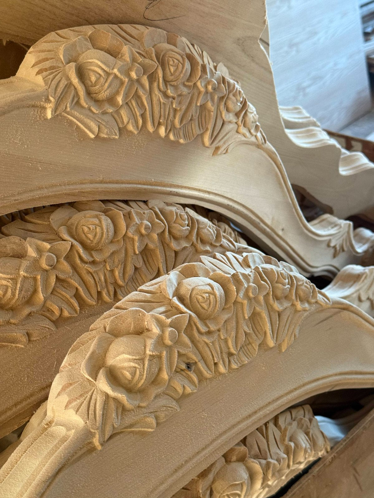 Roses and leaves carved into raw birch before finishing