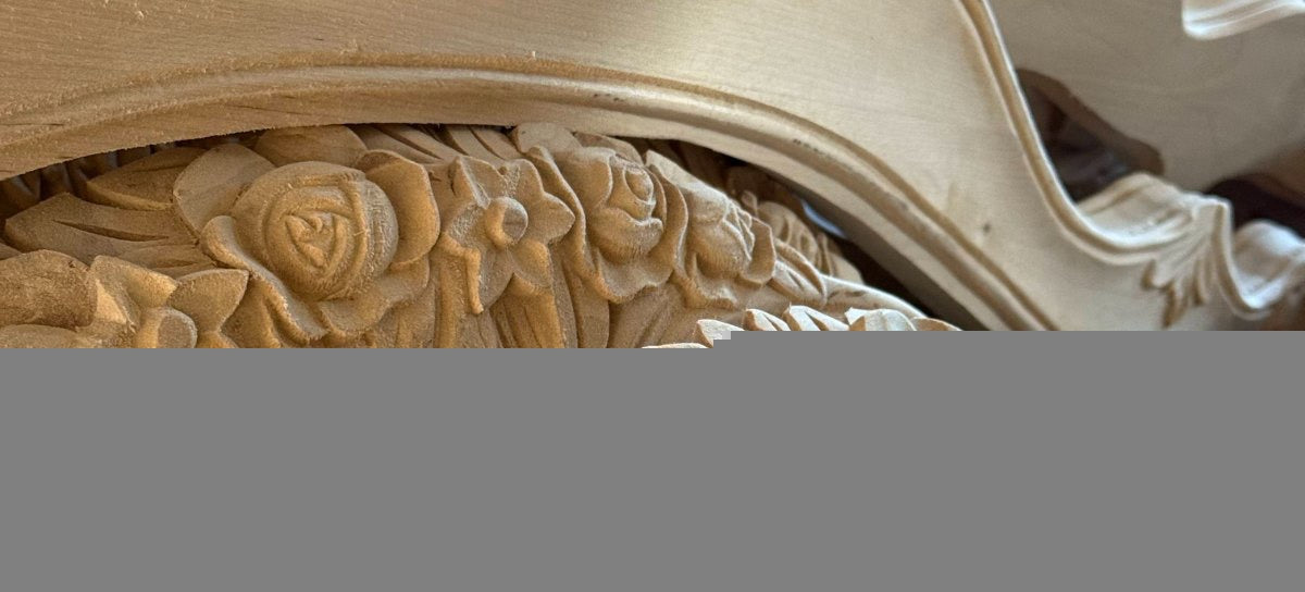 Roses and leaves carved into raw birch before finishing